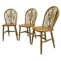 Set of six solid beech Windsor design dining chairs, stick and hoop back with pierced wheel splat, on turned supports united by H-stretchers 