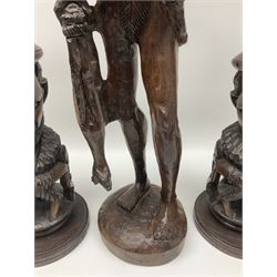 Pair of 20th century carved wood table lamp with African busts and figures, together with a carved wooden figure and soapstone figure, lamps H44cm