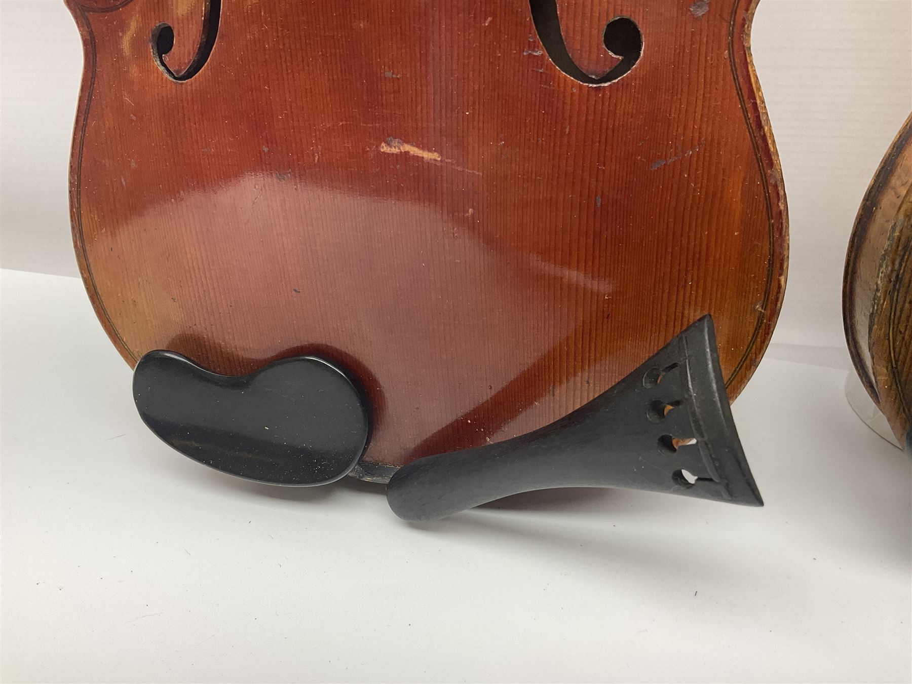 Late 19th century French three-quarter size 'Conservatory' violin with 34cm two-piece maple back and ribs and spruce top, the peg box inscribed 'Conservatory Violin Straduari', bears label 'Antonius Stradiuarius Cremonensis Faciebat Anno 1721' L55.5cm overall; in ebonised wooden 'coffin' case; and Saxony violin c1900 with 36cm two-piece maple back and ribs and spruce top; bears label 'Antonius Stradivarius Cremonensis Faciebat Anno 17**' L59cm overall; in carrying case (2)