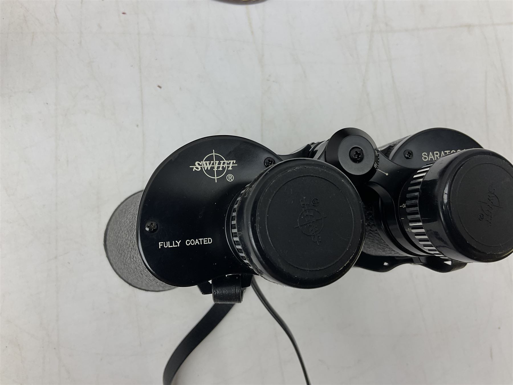 Cast metal nutcracker, in the form of a dog together with a pair of Swift Saratoga 8x40 binoculars in leather case and a hip flask, the glass flask covered in leather to the top with a detachable silver plated cup to base