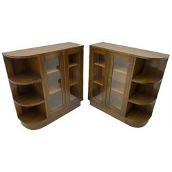 Pair of mid-20th century oak bookcases, rectangular form with curved ends, enclosed by glazed doors and fitted with shelves