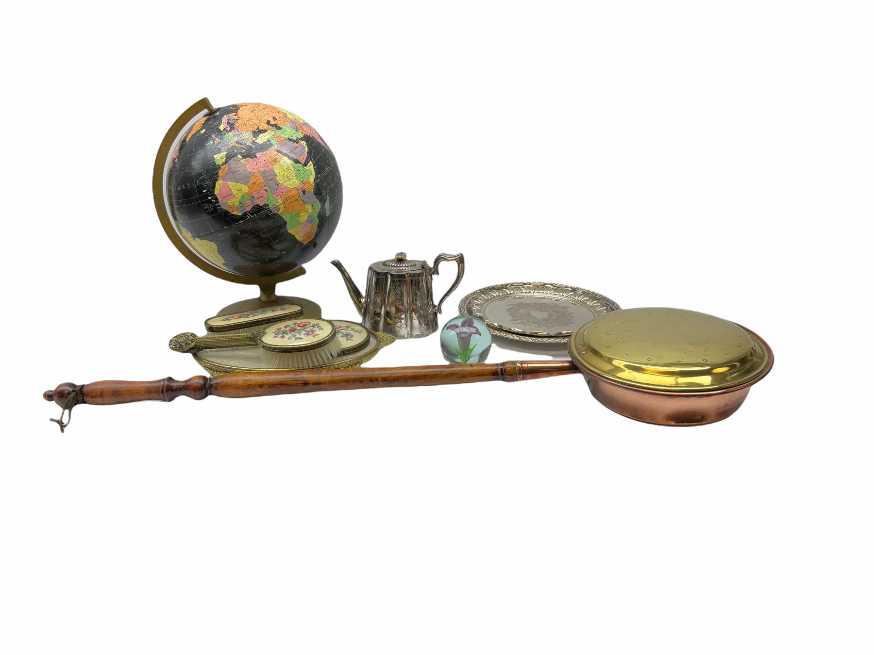 ladies vanity set with floral embroidery backs, comprising mirror, two brushes, comb and tray, along with paperweight with internal floral design, brass and copper bedwarmer, two metal serving trays, a metal teapot and a globe. 