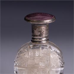 Three silver topped scent bottles, comprising cut glass example with pink guilloche enamel cover, oval example with blue guilloche enamel cover and one other, all hallmarked, largest H6.5cm
