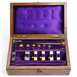 Lord Kelvins Patent electric current balance, no. 823, by Kelvin & James White Ltd Glasgow & London, with two pairs of horizontally mounted coils, suspended beam balance mounted on an ebonite base under glass and brass cover, with box of weights and accessories, raised on three wooden supports, W51cm H37.5cm