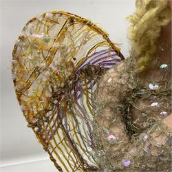 Anna Meszaros Hungary - hand made needlework figurine of an Angel with metallic lace full length dress and open threadwork wings; on moulded base H45cm Auctioneer's Note: Anna Meszaros came to England from her native Hungary in 1959 to marry an English businessman she met while demonstrating her art at the 1958 Brussels Exhibition. Shortly before she left for England she was awarded the title of Folk Artist Master by the Hungarian Government. Anna was a gifted painter of mainly portraits and sculptress before starting to make her figurines which are completely hand made and unique, each with a character and expression of its own. The hands, feet and face are sculptured by layering the material and pulling the features into place with needle and thread. She died in Hull in 1998.