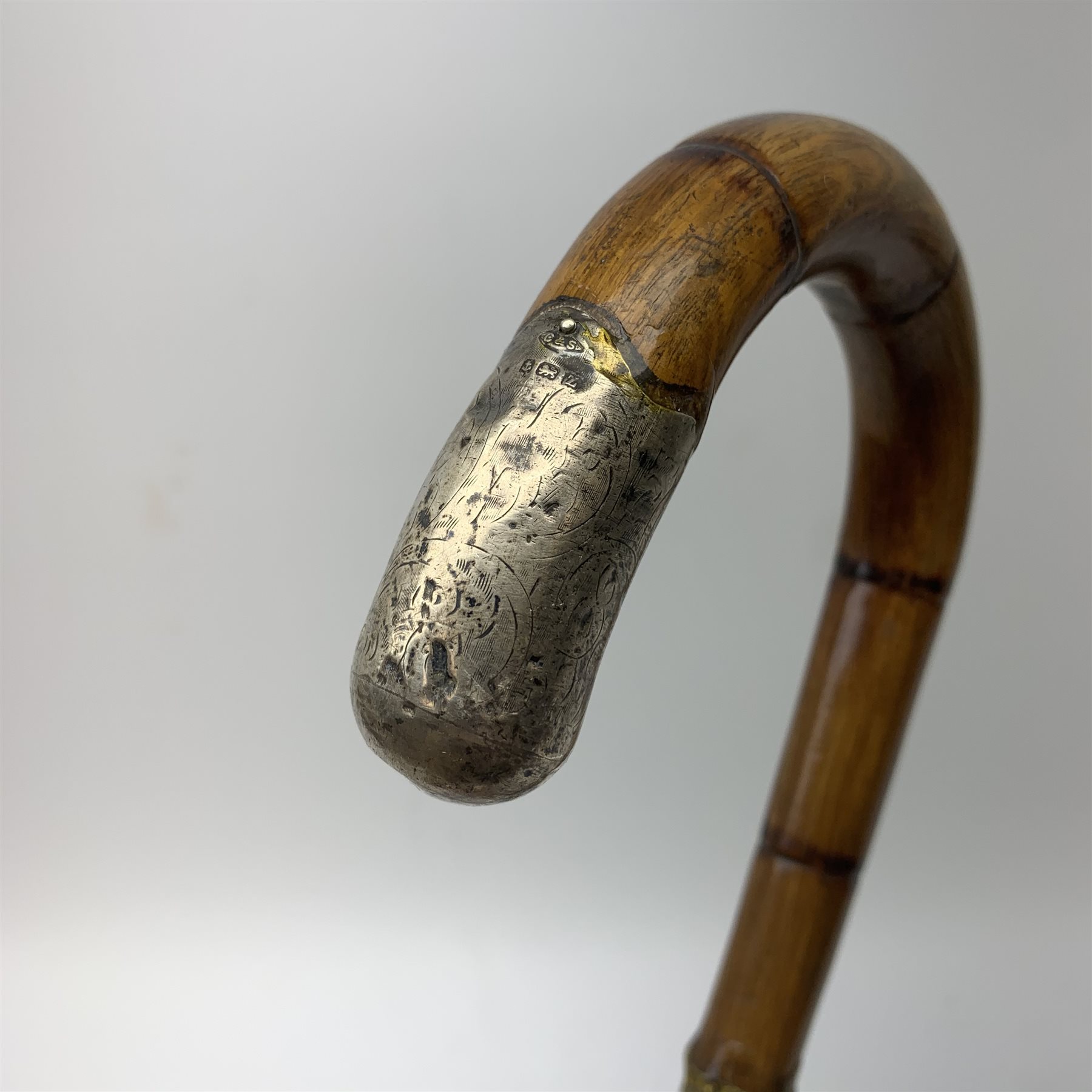 Three silver mounted walking canes, the first hallmarked Kendall & Sons Ltd, London, date letter worn and indistinct, the second hallmarked Birmingham 1924, maker's mark C&S, the third marked Sterling Silver, C&S. 