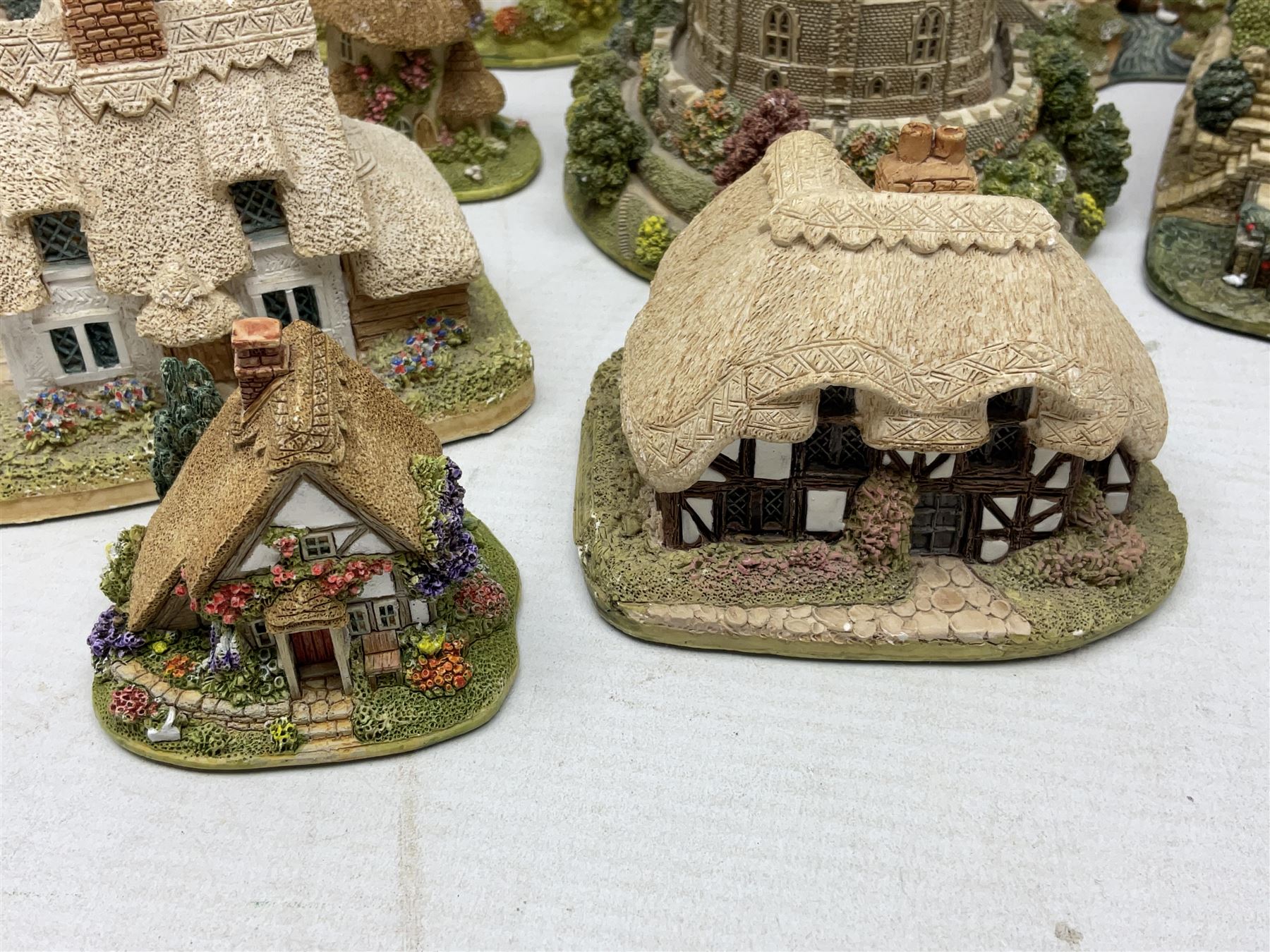 Sixteen Lilliput Lanes, to include The Golden Jubilee, Round Tower - Windsor Castle, Castle of the Golden Chalice, Travellers Rest, with box and deed,  Summer Days, Sunshine Creek, Writing with Lewis Carol, with box and deed,  etc 