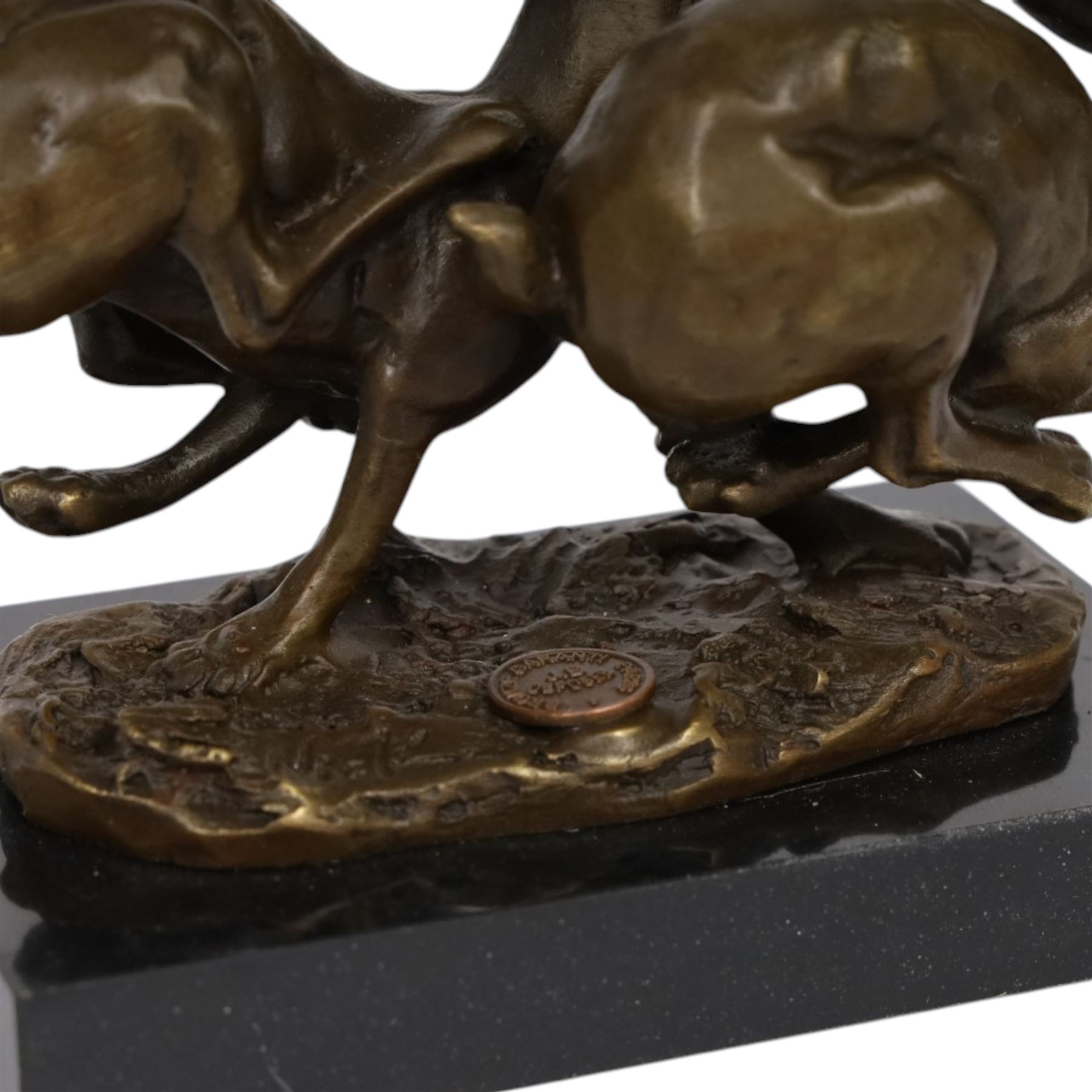 Bronze figure group, modelled two hares in chase, upon naturalistically modelled oval base signed Nick and with foundry mark, raised upon black marble base, H11cm L12.5cm