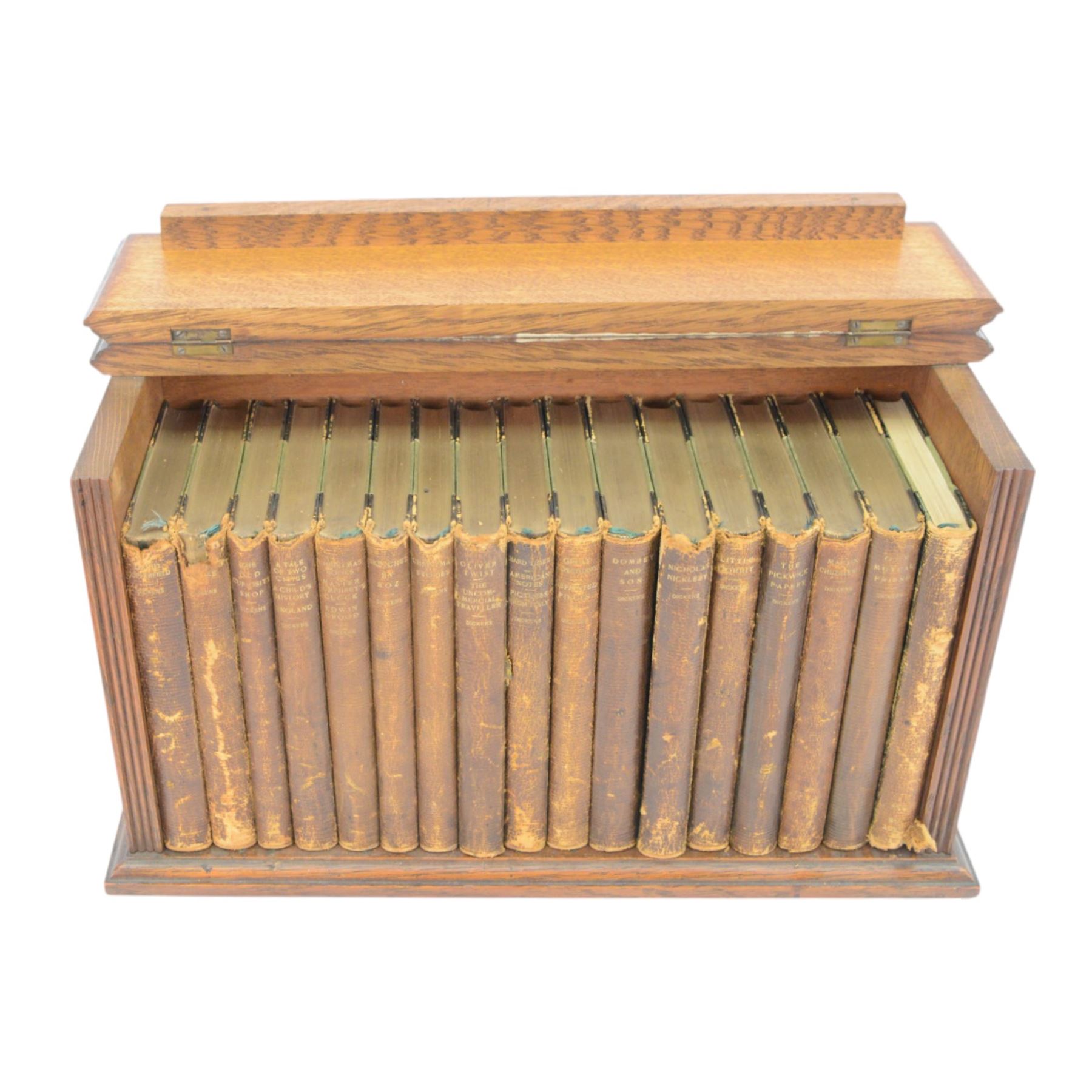 Dickens Charles, The Complete Works of Charles Dickens, 17 Vols, illustrations by 'Phiz', London, Chapman & Hall, Limited; and Henry Frowde, New York; Oxford University Press American Branch, later replaced boards, housed within an oak table top bookcase, with hinged lid, titled 'The Complete Work of Charles Dickens', together with a number of other books

