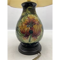 Moorcroft table lamp of baluster form, decorated in Fire Flower pattern, with Moorcroft cream fabric shade with gold, green and red piping, overall H46cm
