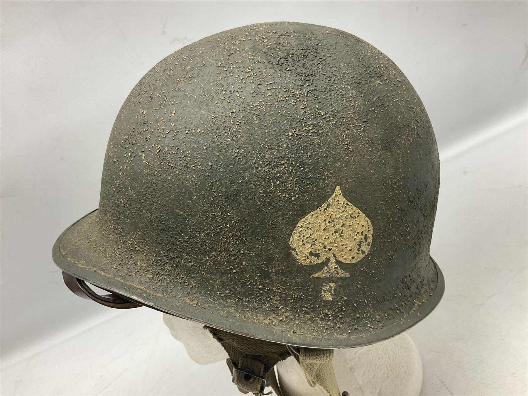 American first type paratrooper helmet with post-WW2 strap and D-rings and later 1944 liner bearing Firestone Tyre and Rubber Company mark; green textured finish