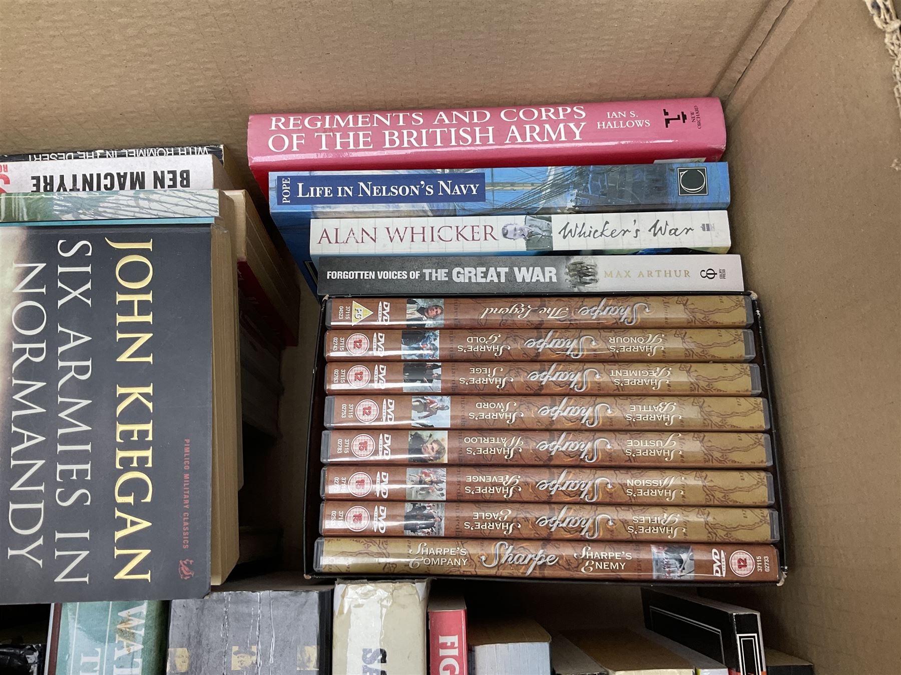Large collection of hardback and paperback books, mainly military books, to include Band of Brothers, Dawn of D-Day, Dessert Warrior, Book of the Somme, Battle of Britain, etc in four boxes  