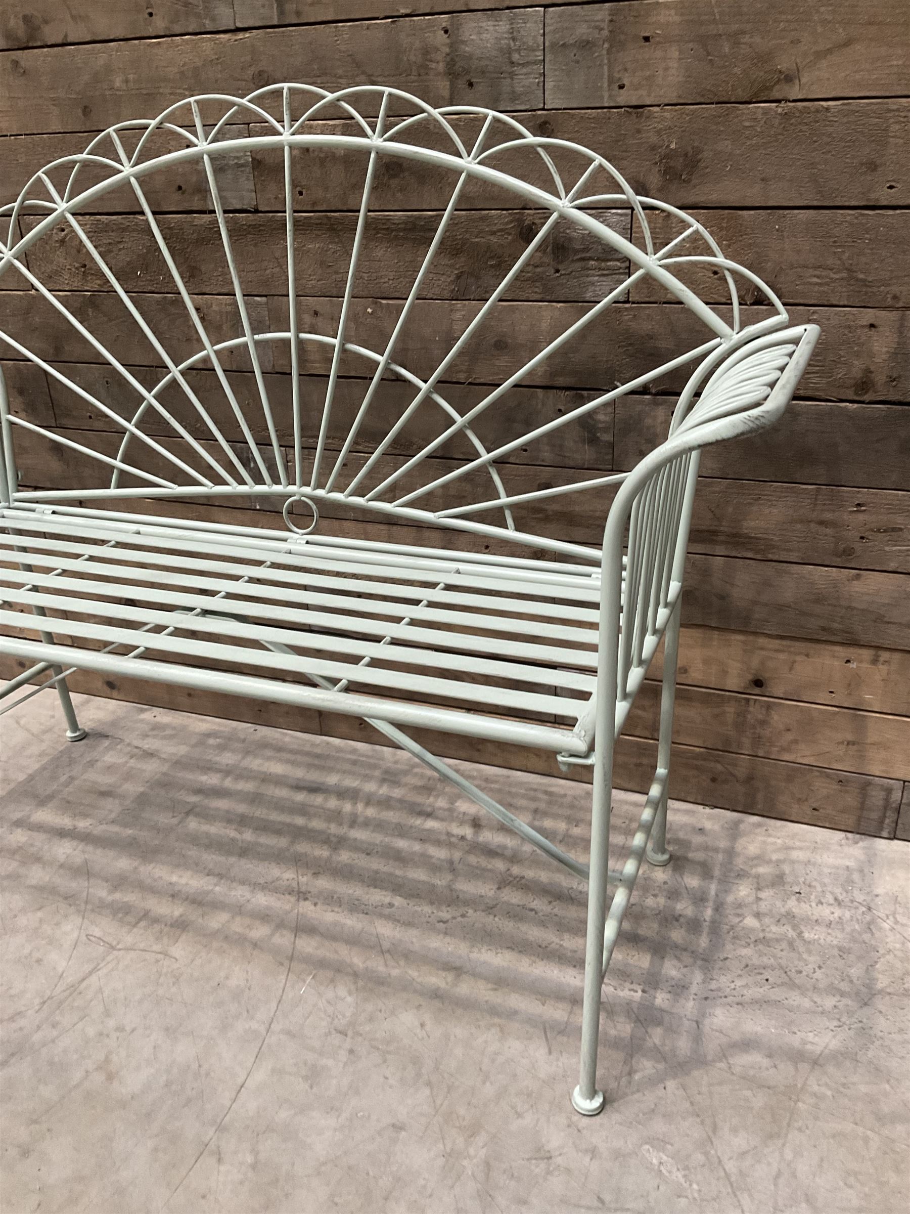 Wrought metal two seat garden bench, sunburst back, painted in pale green finish