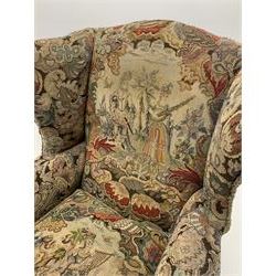 Matched pair early 20th century Queen Anne style wingback armchairs, walnut framed, sprung seats with seat cushions upholstered in needle work cover, shell carved cabriole front feet