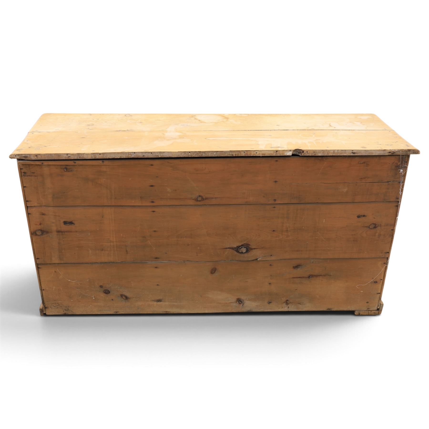 Victorian stripped pine sideboard, rectangular plank top rounded edges, with central cupboard door with shaped panel, flanked by two banks of three graduating drawers with turned knobs, raised on a plinth base 