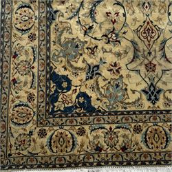Nain Persian rug, hand knotted with a central medallion surrounded by a symmetrical arrangement of floral motifs, arabesques, curvilinear vines on an ivory background with teal and burgundy colours 