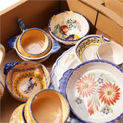 Collection of Quimper faience items including plates, cups, bowls and jug etc