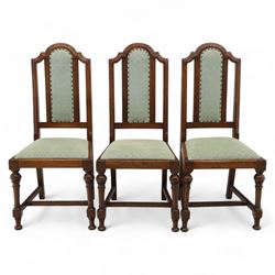 Victorian mahogany extending dining table, rectangular top with chamfered corners above a plain frieze raised on turned reeded legs with castors and two additional leaves, 197cm fully extended, and a set of six early 20th century oak upholstered chairs with drop-in seats, arched panelled back splat and close studded border on turned front legs joined by stretchers, 47x41x109cm 