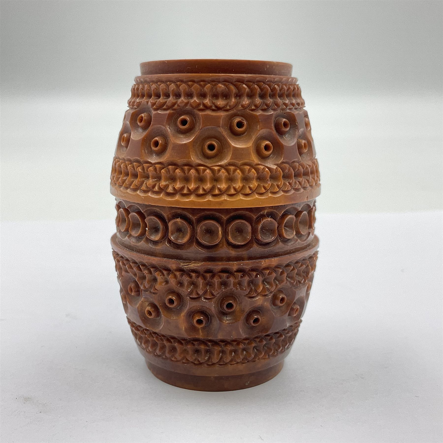 Three 19th century coquilla nut pomanders or flea catchers, two of egg shaped form and the third of barrel from with carved and pierced decoration and screw threaded join, largest H8cm