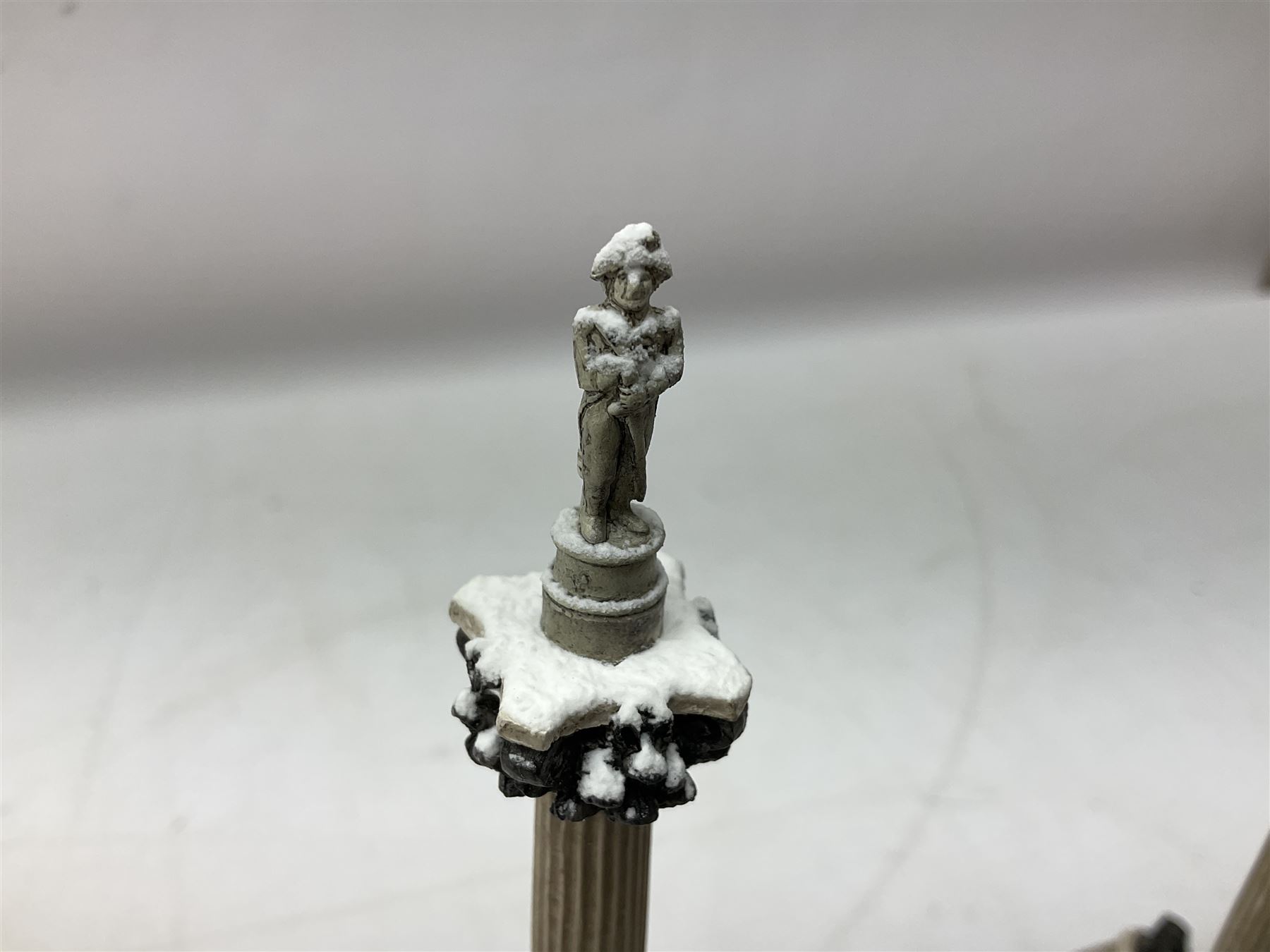 Five Lilliput Lane models from the 'Britain's Heritage' collection, comprising The Royal Albert Hall, Windsor Castle Round Tower, Eros and Nelson's Column and another snowed, all boxed