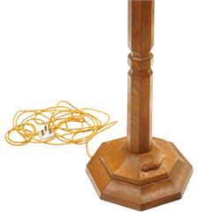 Mouseman - oak standard lamp, the turned octagonal column terminating to a stepped cavetto octagonal base, with carved mouse signature, by the workshop of Robert Thompson of Kilburn
