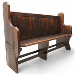Victorian pine pew or bench, panelled back with book raised over plank seat, on shaped end supports united by stretcher 