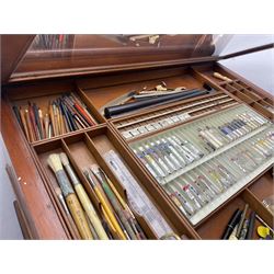 Edwardian mahogany artist's cabinet once belonging to the British artist Eli Marsden Wilson (1877-1965), raised panelled back mounted by carved brackets, sloped and hinged glazed lid enclosing paint holders and compartments, up-and-over panelled door revealing three slides, fitted with two banks of five graduating drawers with recessed brass handles, on skirted base.

Together with a quantity of artists' equipment and tools including paints, paintbrushes, charcoal, chalks, etc. and various prints relating to the life of the artist, including Quaker anti-war posters, Victorian Stevengraphs, and various chromolithographs 

Provenance: Removed from the studio of Eli Marsden Wilson. The cabinet comes to us for sale through family descent. The vendor is descendant of Marsden. Many further etchings removed from the cabinet are being sold in the Spring Art Sale, Friday 15th March 2024, Lots 265-271.

Notes: born in Ossett, Eli Marsden Wilson was the only son of Alfred Wilson, a foreman beamer, and Emma Marsden, and had five sisters. After studying at Wakefield College of Art, he moved to the Royal College of Art in London, where he became a pupil of Sir Frank Short. He had his first exhibit at the Royal Academy in 1905, the same year he married fellow artist Hilda Mary Pemberton.

A Quaker, vegetarian, and pacifist, he was a conscientious objector in World War I and as such was imprisoned in 1917 for two years. In September 1922 he was commissioned by Princess Marie Louise to produce miniature etchings for Queen Mary's Dolls' House at Windsor Castle; two such etchings are being sold in the Spring Art Sale, Friday 15th March 2024, Lot 265.