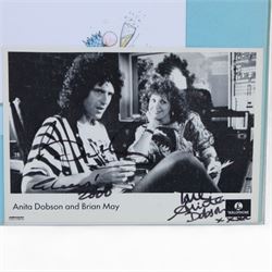 Birthday card and postcard, each signed by Brian May and Anita Dobson, with a personalised Anita Dobson compliment slip dated 2008, in glass frame