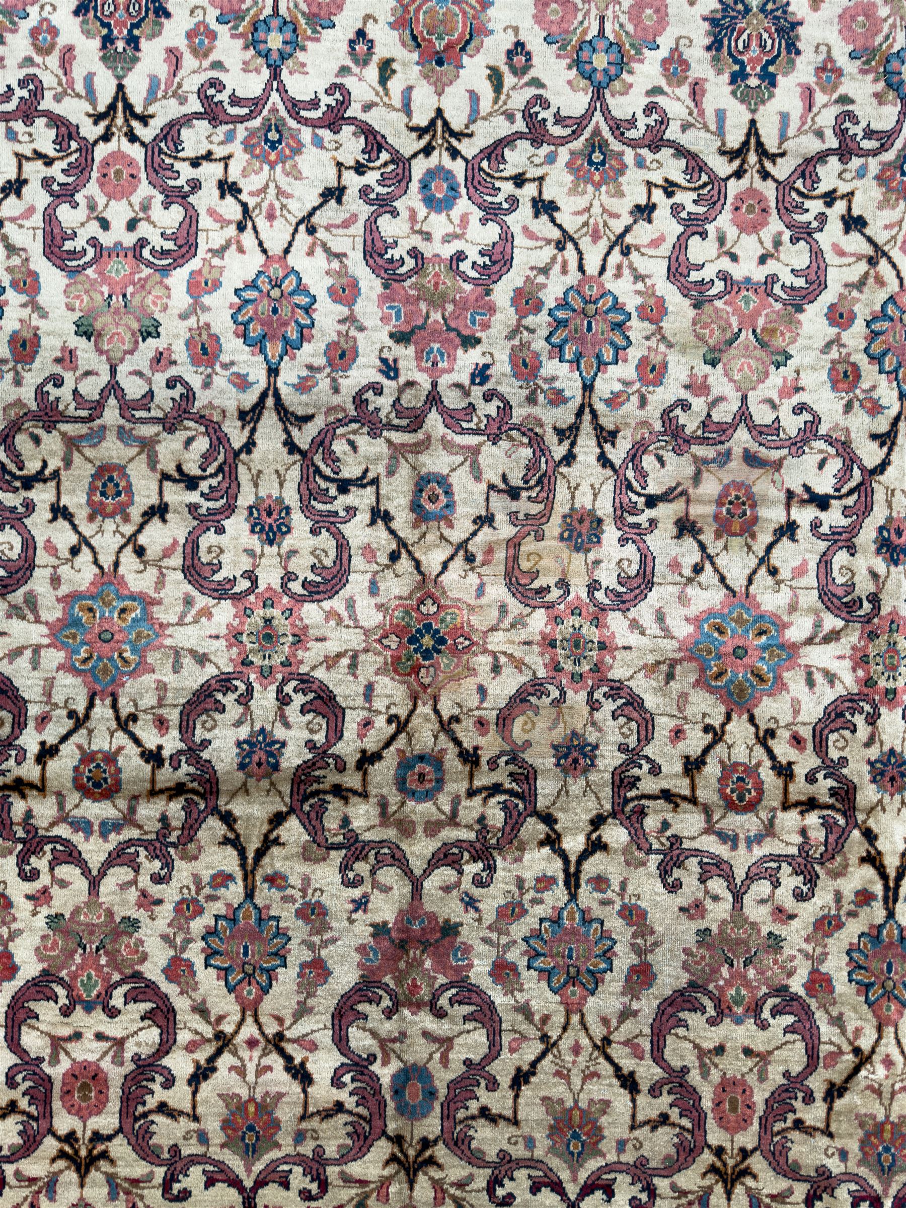 Northwestern Persian Meshkin hand-knotted carpet, the ivory field with an all-over design of scrolling vines and stylised floral sprays in burgundy, pink, and blue tones, enclosed by a raspberry red border of rosettes and palmettes linked by fine arabesques, from the region of Meshkin near Ardabil
