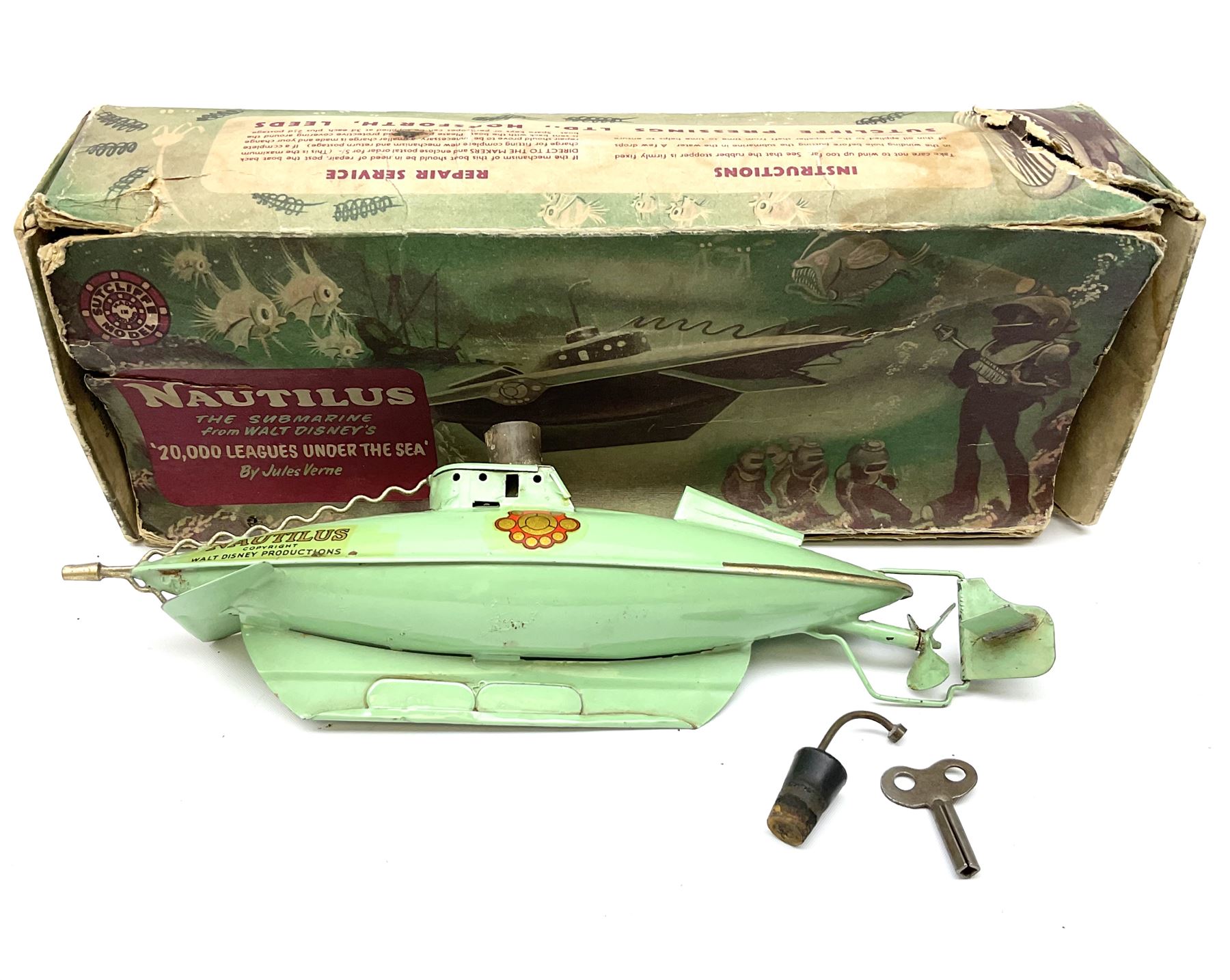Sutcliffe Models ‘Nautilus’ tinplate and clockwork submarine from Walt Disney’s ’20,000 Leagues Under The Sea’ by Jules Verne, sea green body with various decals, rubber bung with periscope, boxed with inner cardboard display piece, produced between 1955-1960