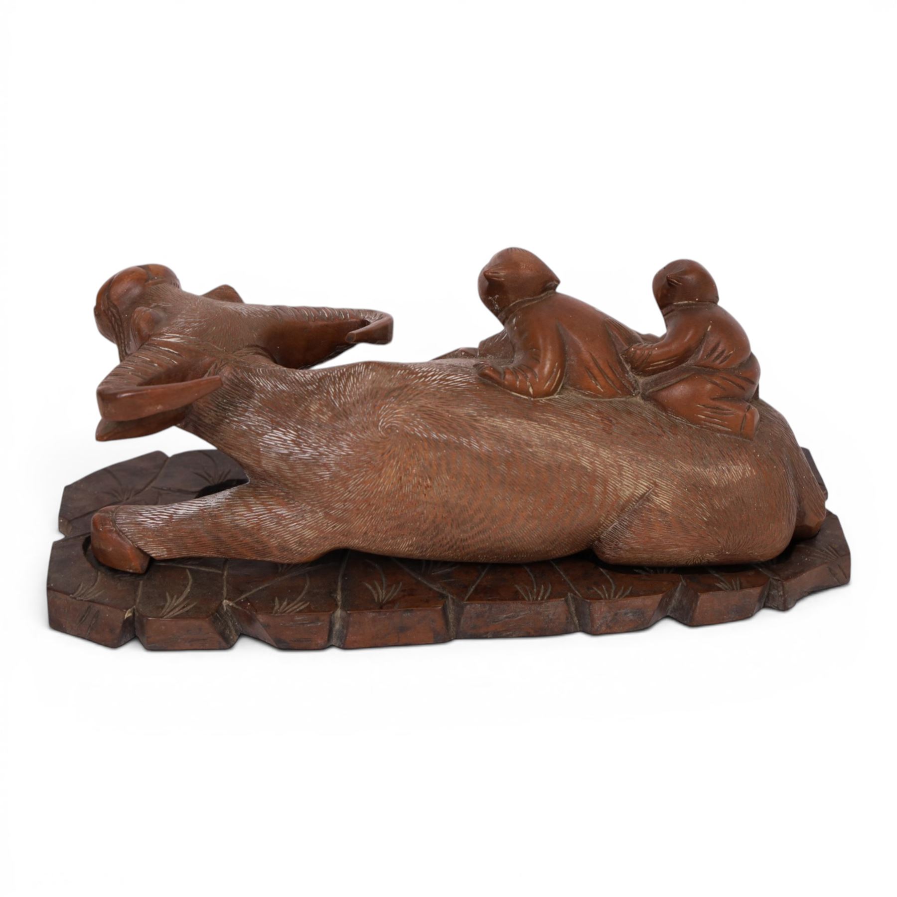 Chinese carved hardwood figural group of two boys climbing on the back of a water buffalo, sitting on a carved and pierced hardwood stand, W30cm; together with a carved reclining figure of a woman and a figure of a tiger (3)