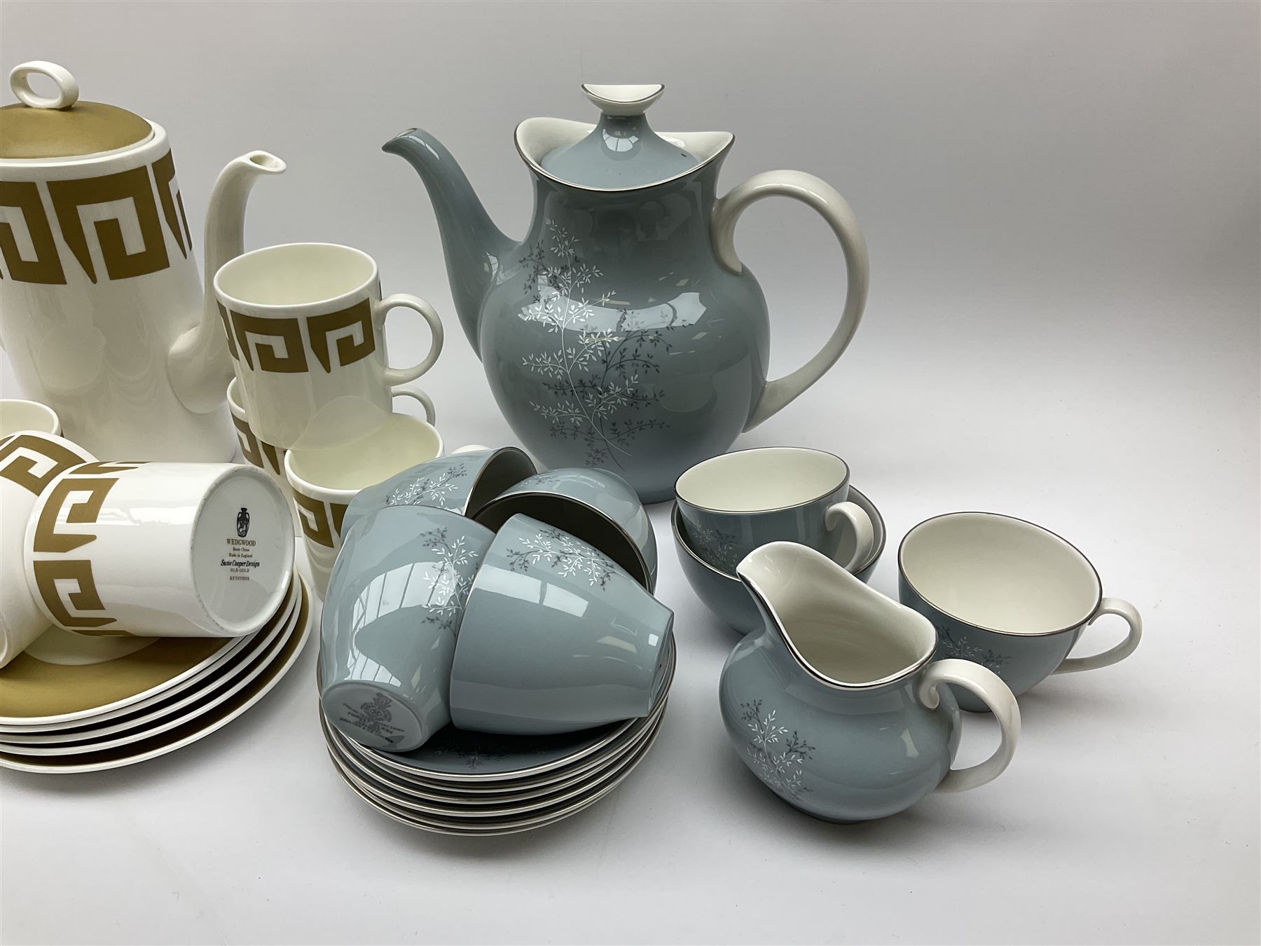Royal Doulton Forest Glade pattern tea set, comprising teapot, milk jug, open sucrier, six cups and saucers, together with a Wedgwood Susie Cooper tea set, with Greek key decoration, comprising coffee pot, six cups and five saucers, open sucrier and milk jug.