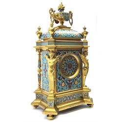 19th century French ormolu and champlevé enamel mantel clock, the twin handled urn with fruit and flower cast finial on cushion top, each corner set with urn, the front canted corners decorated with winged caryatid figures, turquoise ground champlevé work with scrolling floral pattern, twin train movement striking on bell by Japy Freres