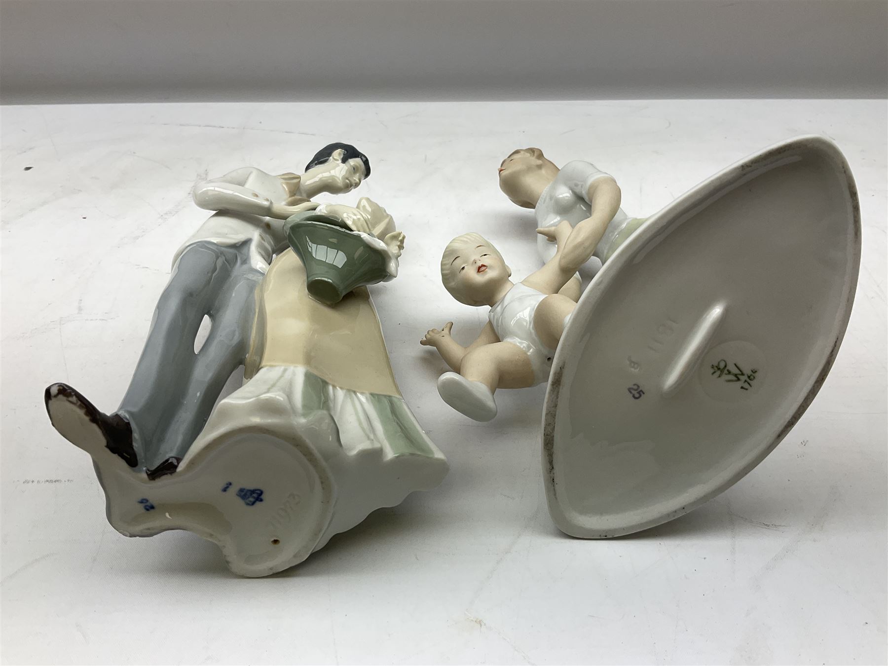 Six Karl Ens figures of birds, together with a Wallendorf figure of mother and child and four, Kunstporzellan bust of a baby and three other figure groups, tallest example H27cm
