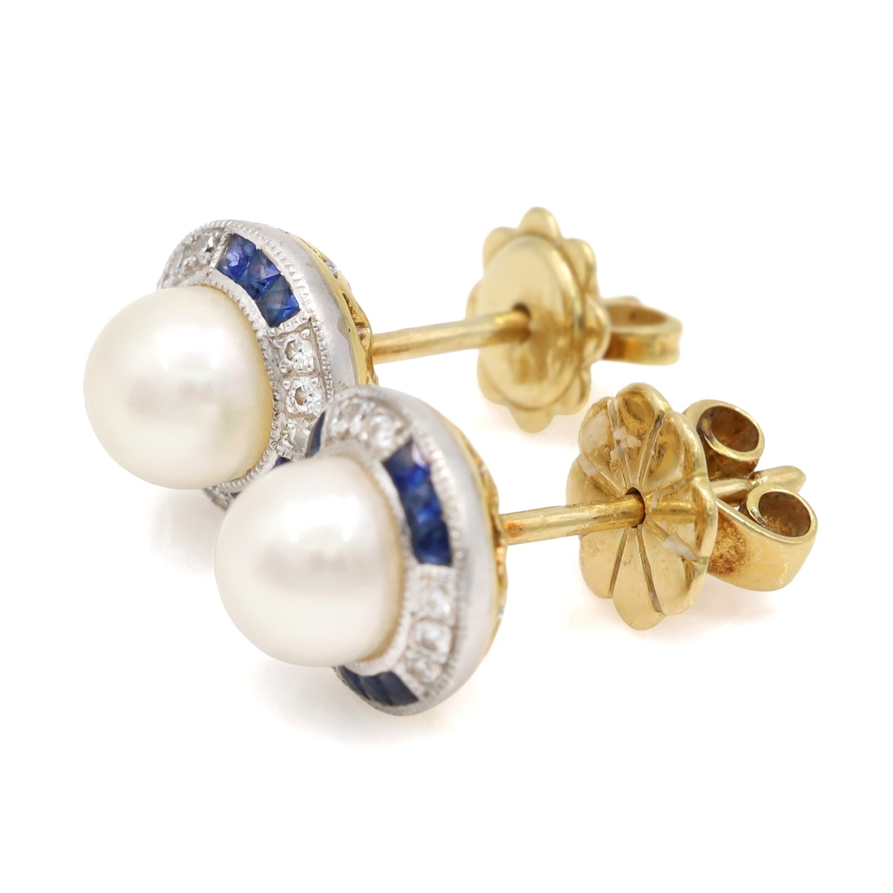 Pair of pearl, sapphire and diamond milgrain set earrings, each stud set with a cultured white pearl, surrounded by alternate calibre cut sapphires and round brilliant cut diamonds, London import mark 1994