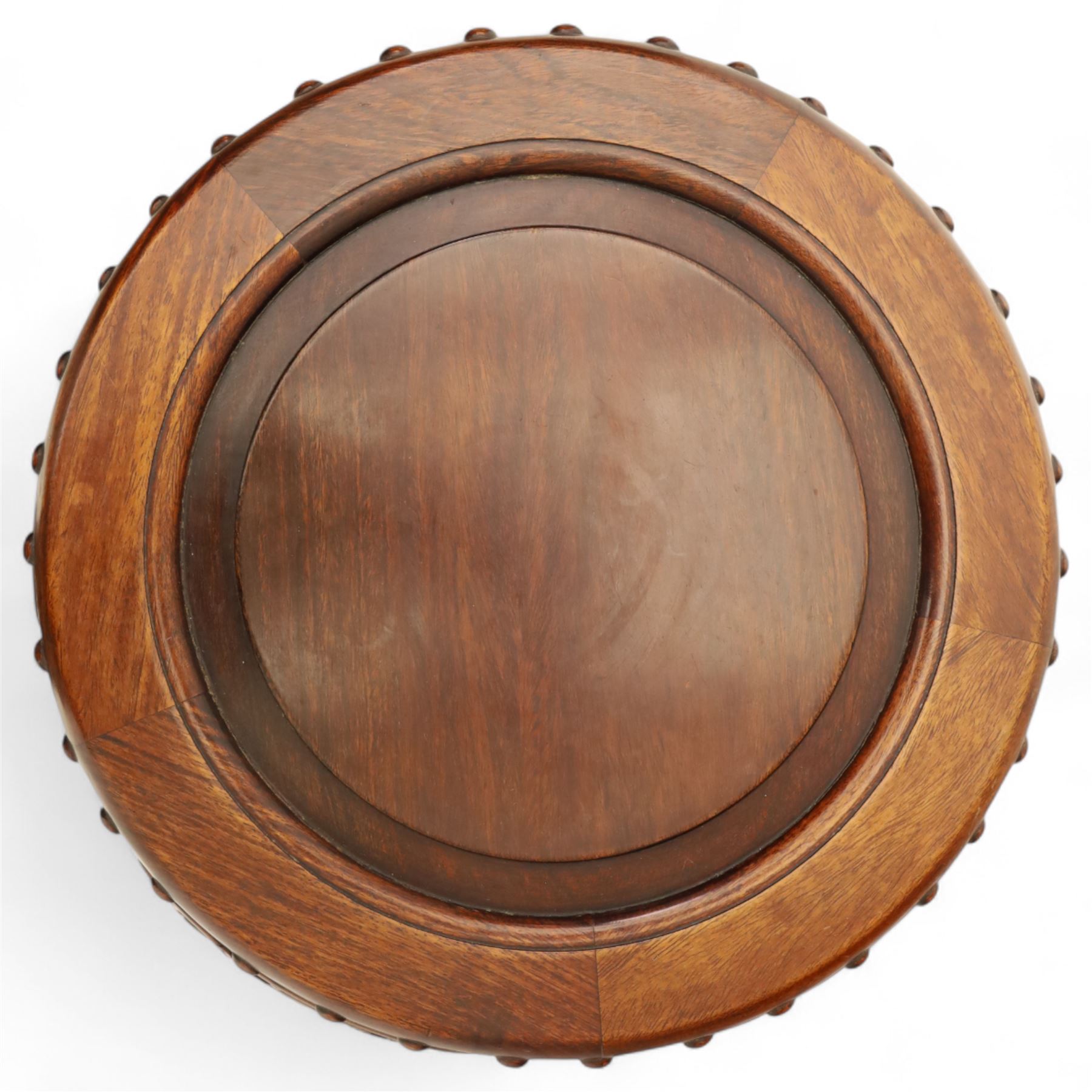 Pair of early 20th century Oriental hardwood barrel seats, of drum form with shaped apron and pierced panels, carved with stylised scrollwork and studded detail to the top