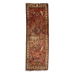 Belgian Sultan woollen ground rug, central navy field densely decorated with floral sprays and geometric patterns (192cm x 135cm); handwoven tribal terracotta ground rug (121cm x 71cm); Persian crimson ground runner, all over stylised floral and foliate motifs (266cm x 94cm)