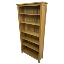 Contemporary light oak open bookcase, fitted with five adjustable shelves