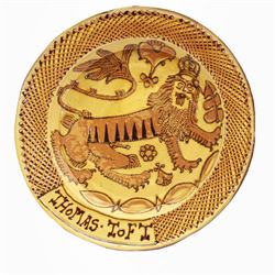 John Hudson: Large slipware charger in the style of Thomas Toft by John Hudson of Mirfield Pottery, decorated with the lion supporter taken by Toft from the Royal Arms, incised marks verso, D 44cm.
