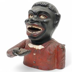 American painted cast iron money bank 'William Tell', the base marked 'Patented June 1896' L26cm and a 'Jolly Nigger' money bank (2)