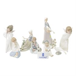 Eight Lladro figures, comprising Curious Angel 4960, Mime Angel 4959, Angel with Mandolin ...