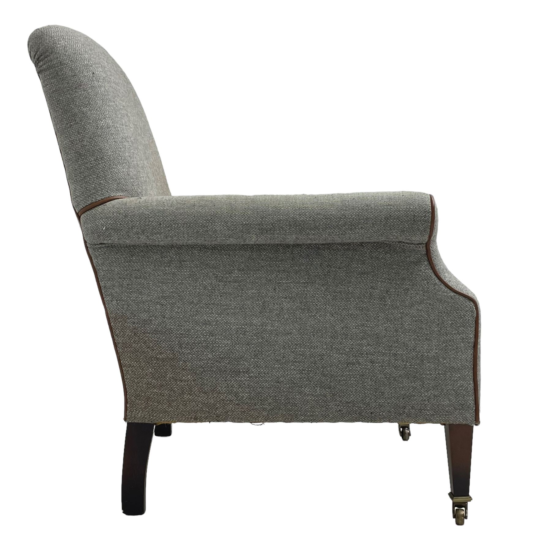 Interiors at Nine to Eleven - Edwardian design armchair, traditional shape with rolled arms, upholstered in 'Harris Tweed' fabric with leather piping, raised on square taping supports with castors
