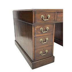 George III mahogany twin pedestal partner's desk, moulded rectangular caddy top with tooled leather inset, one side fitted with nine drawers and the opposing side fitted with single drawer, two false drawers and two panelled cupboards, ornate cast gilt metal handles and handle plates, on plinth base