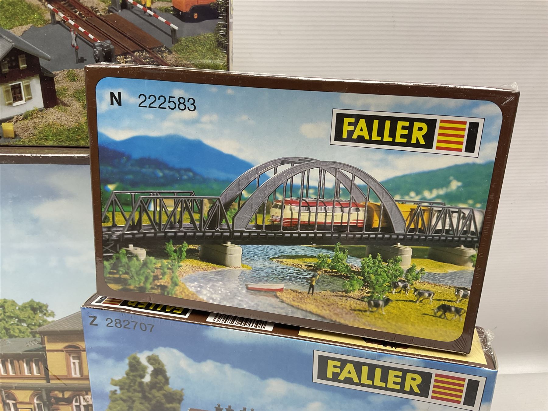 'N' gauge trackside accessories - seven Faller buildings and bridges etc Nos.N212113, N222121, N222583, N222174, N222128, Z282730 & Z282707; two others by Vollmer Nos.N7657 & N7724; four boxes of Gaugemaster Ballasted Underlay; grit and Foliage Clusters