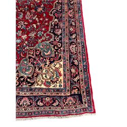 North West Persian Bidjar red ground carpet, shaped pole medallion surrounded by interlacing branches and stylised flower heads, five band border with repeating floral design
