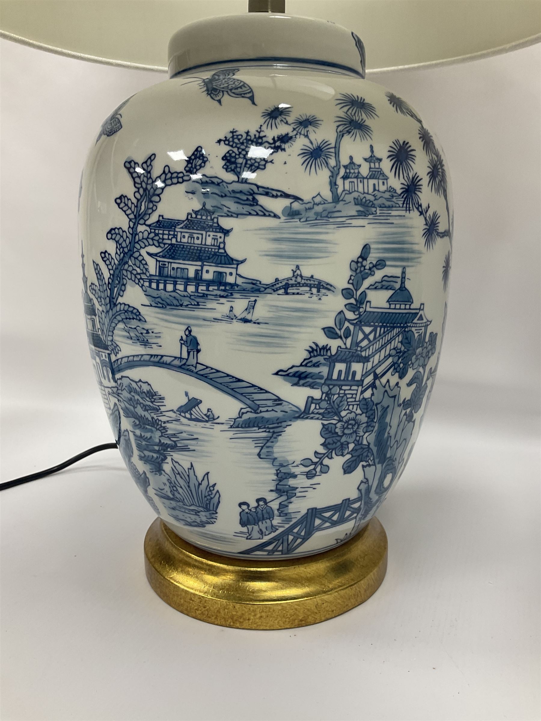 Pair of Chinese table lamps of baluster form, each decorated with landscape scene, raised upon gilt circular base, including shade H63cm