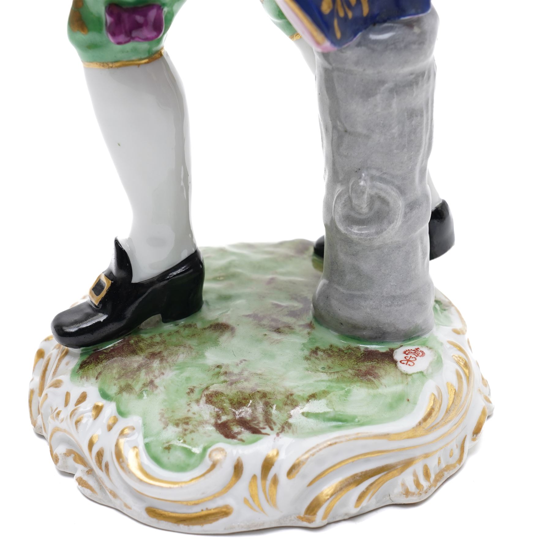 Pair of 19th century Samson of Paris figures of male and female itinerant milliners, each holding a basket with ribbons and flowers on rococo style gilt bases H33cm