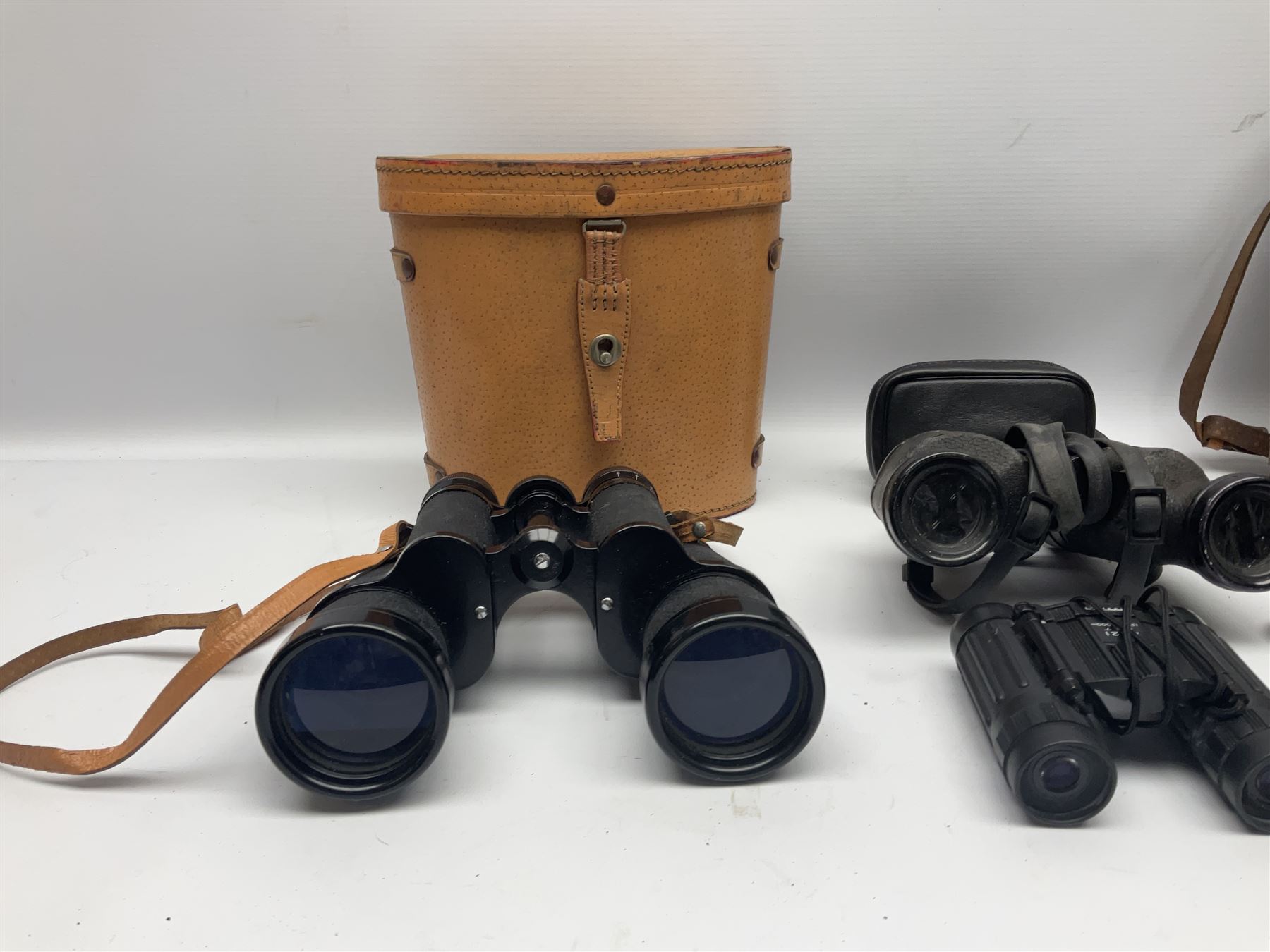 Pair of British World War Two issue black-painted binoculars, Bino 7x50 No. 5, 6E/320, No. 87412, MoD.B/42, with case, together with Nipole 10 x 50 binoculars and two other pairs