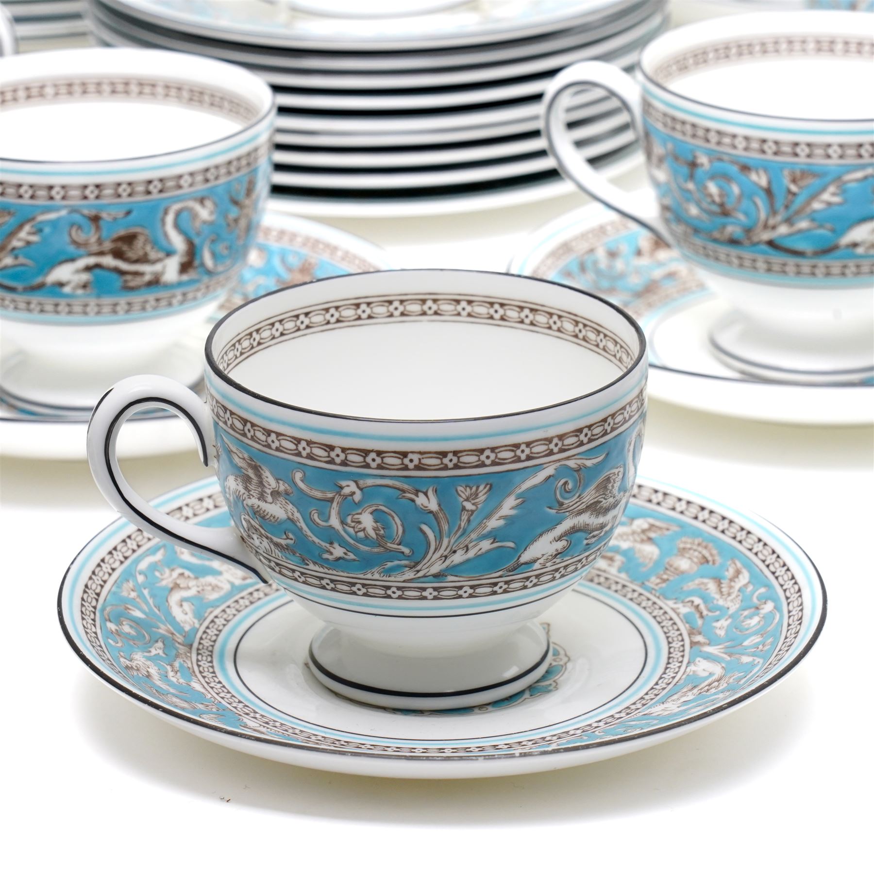 Wedgwood turquoise Florentine part service, comprising large covered tureen and stand, coffee pot, teapot, two covered sucriers, milk jug, two sauce boats and stands, seven soup plates, three bowls, jug, eighteen soup bowls and fifteen stands, two ashtrays, thirteen further saucers, twelve teacups and eleven saucers, and twenty-one further plates of varying sizes