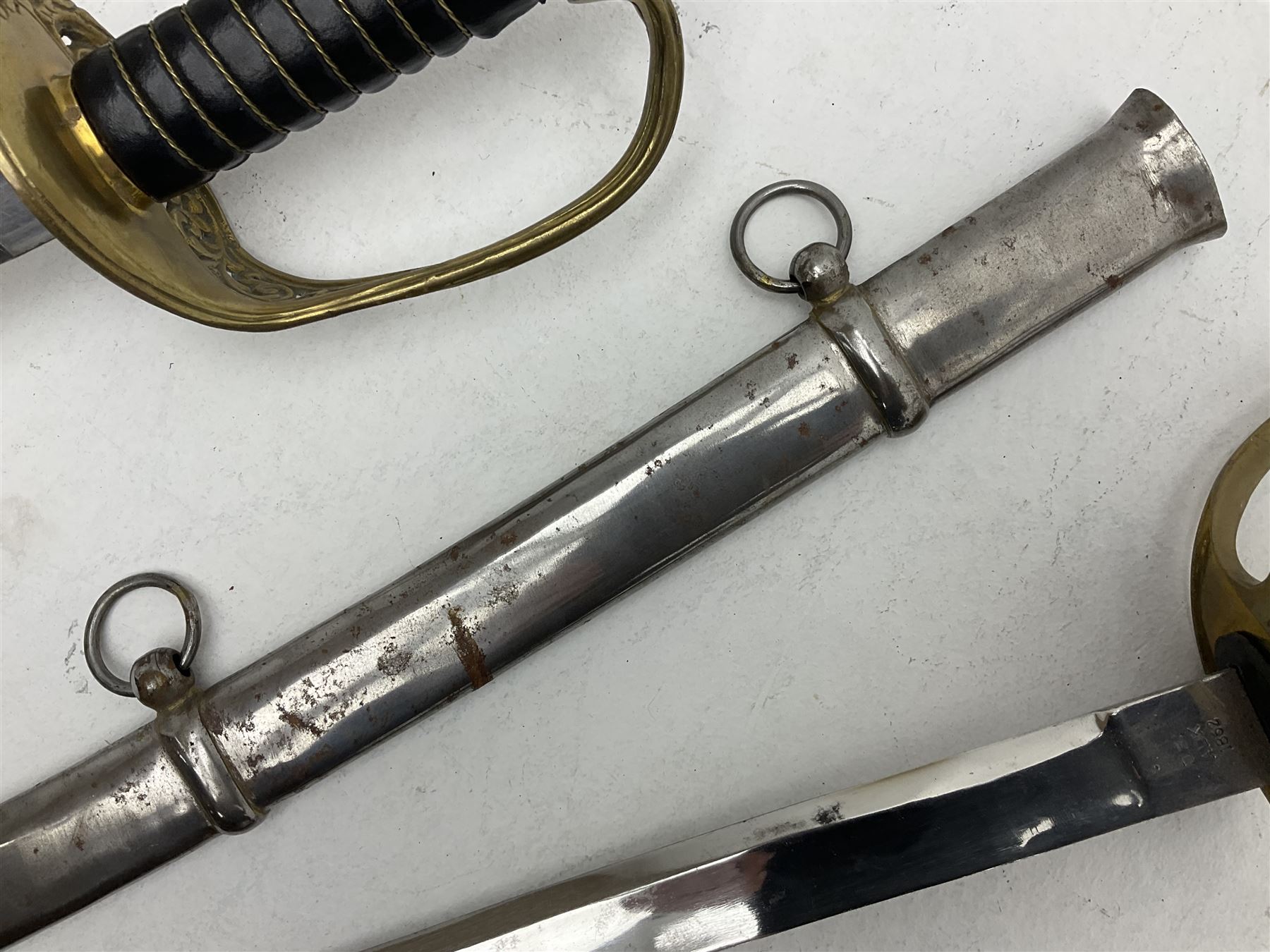 Reproduction American Civil War Cavalry trooper's sword, the 88cm slightly curving fullered steel blade marked to the ricasso 'Ames & Co Chicopee Mass.' and 'US ADK 1862'; brass hilt and leather covered grip; in steel scabbard L110cm overall;  and another reproduction sword (2)
